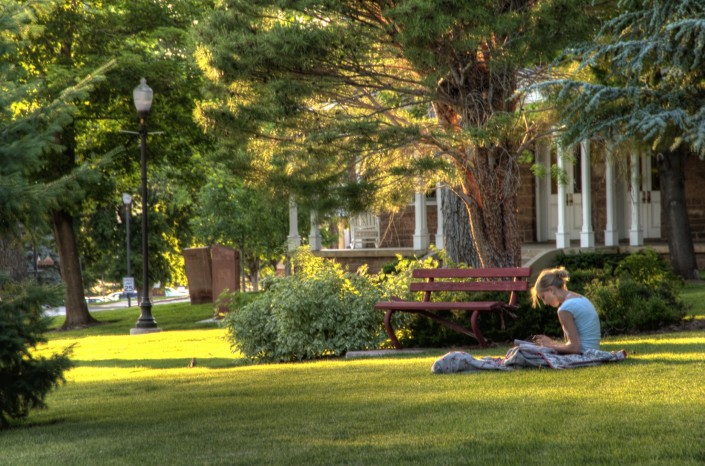 A student enjoying studying in the afternoon sunlight. Captured for the University of Utah.